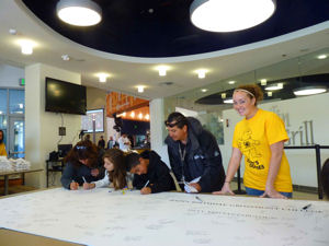 Community members sign Grossmont College’s 50th birthday card.