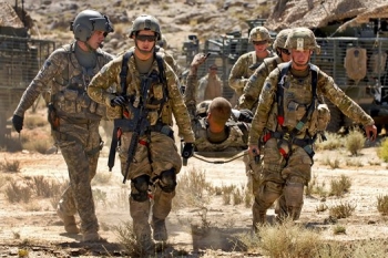 U.S. Army Pfc. Shawn Williams gives thumbs-up during evacuation after he was injured by a roadside bomb in Afghanistan June 17th. Photo by Lt. J.G.. Haraz N. Ghanbari
